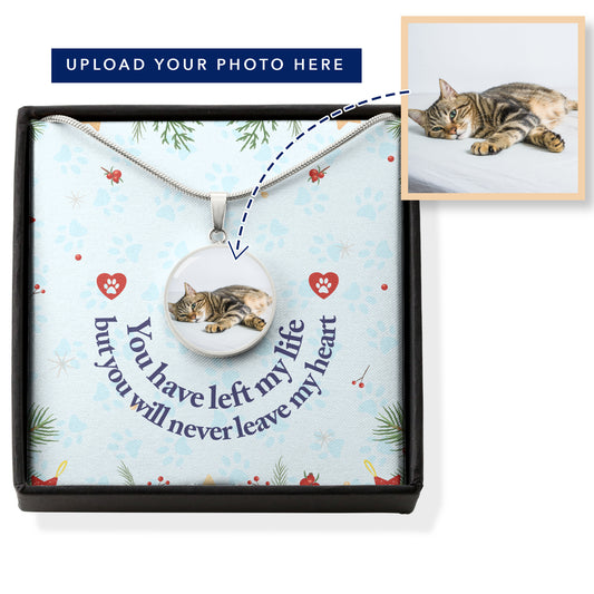 You have left my life but you will never leave my heart pawprint message greeting card gift box holds the round stainless steel photo charm memorial pendant on a smooth snake link chain. Image has explainer text, "Upload Your Photo Here" with an arrow from a photo showing the photo inside the necklace's charm.