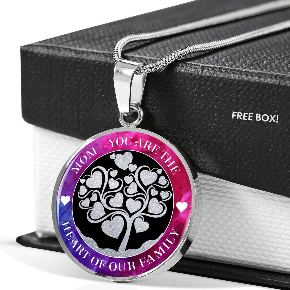 Mom - You are the Heart of our Family Stainless Steel Necklace drapes over it's black and white gift box with it's snake link chain lying over the top of the box lid, with the pendant resting against the side of the box.