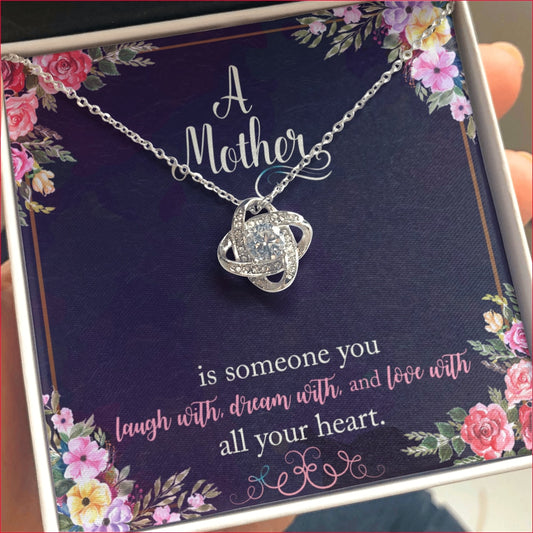 A Mother is someone you laugh with, dream with, and love with all your heart. CZ Love Knot Pendant with a floral meaningful message inside gift box which holds the white gold and cubic zirconia love knot pendant.