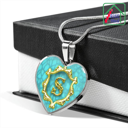 S Initial Monogram Alphabet Heart Pendant and Necklace Turquoise Background draped over giftbox