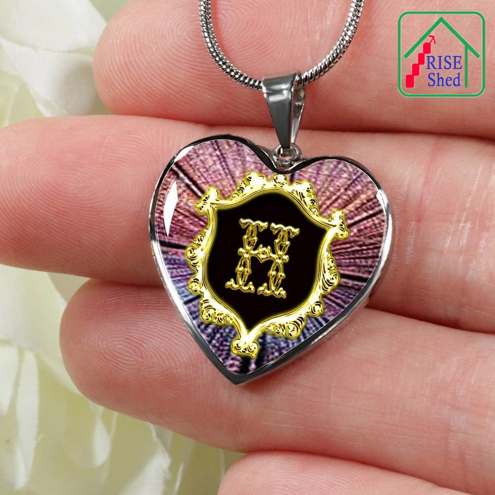 Close Up of H Initial Monogram Alphabet Heart Pendant and Necklace held in hand