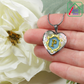 holding the Valentines P Initial Monogram Heart Pendant from necklace against fingers