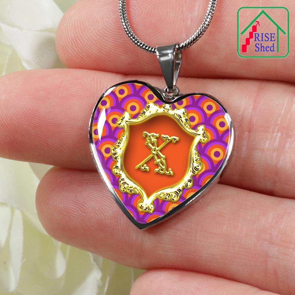 Close Up of X Initial Monogram Alphabet Heart Pendant and Necklace held in hand