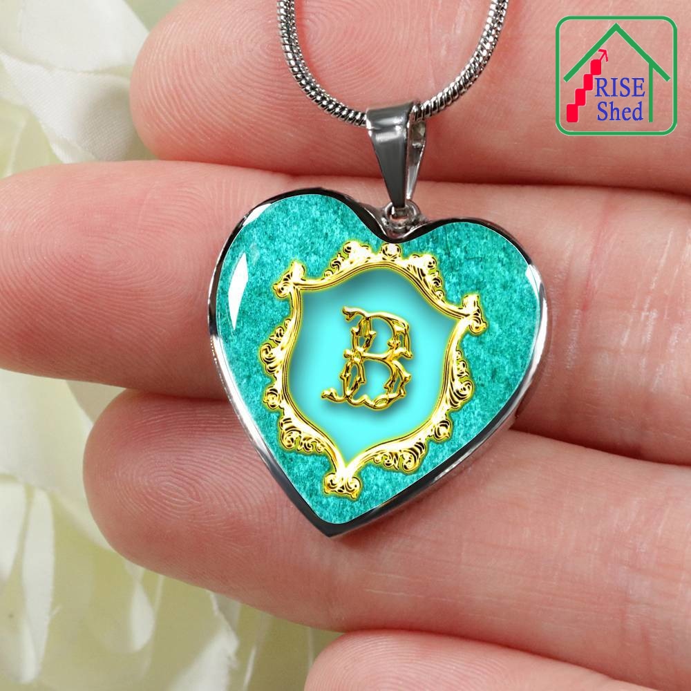 Close up of B Initial Monogram Alphabet Heart Pendant and Necklace held in hand