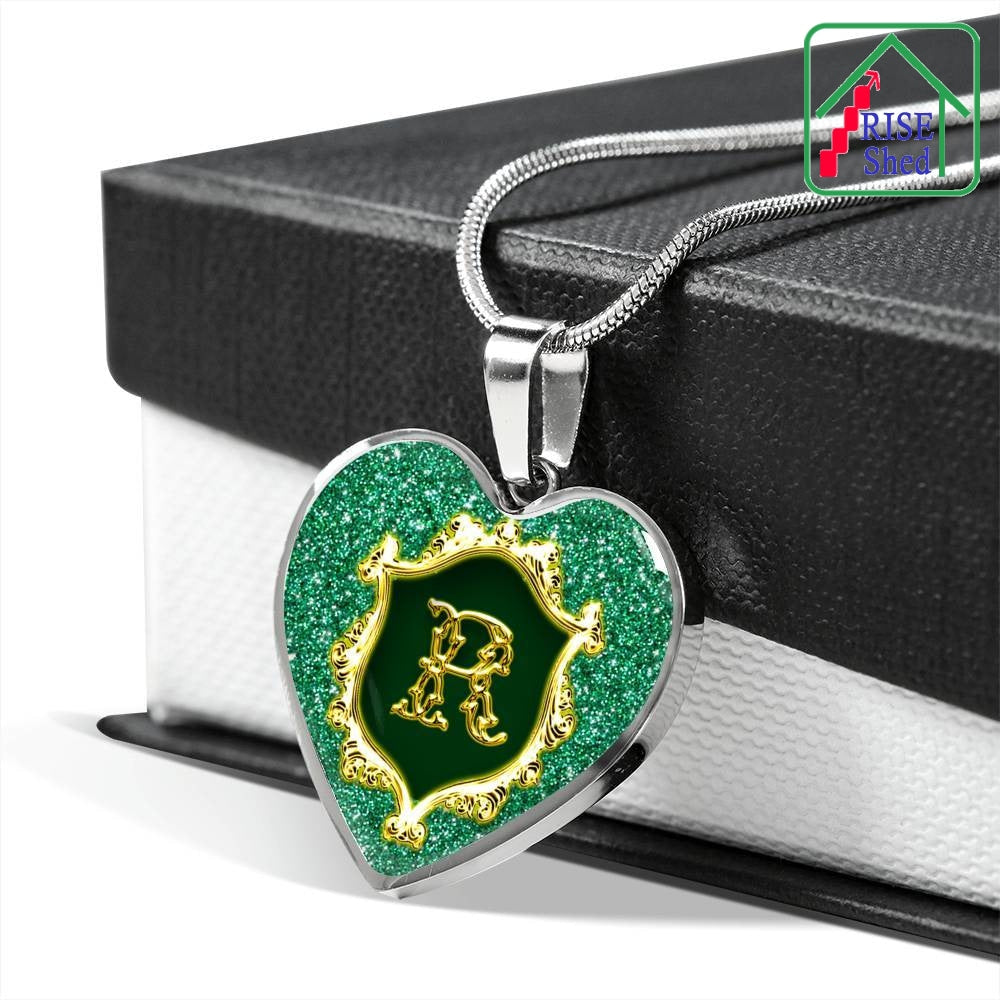 R Monogram Heart Pendant Alphabet Initial Necklace lays over the top of giftbox with a black lid