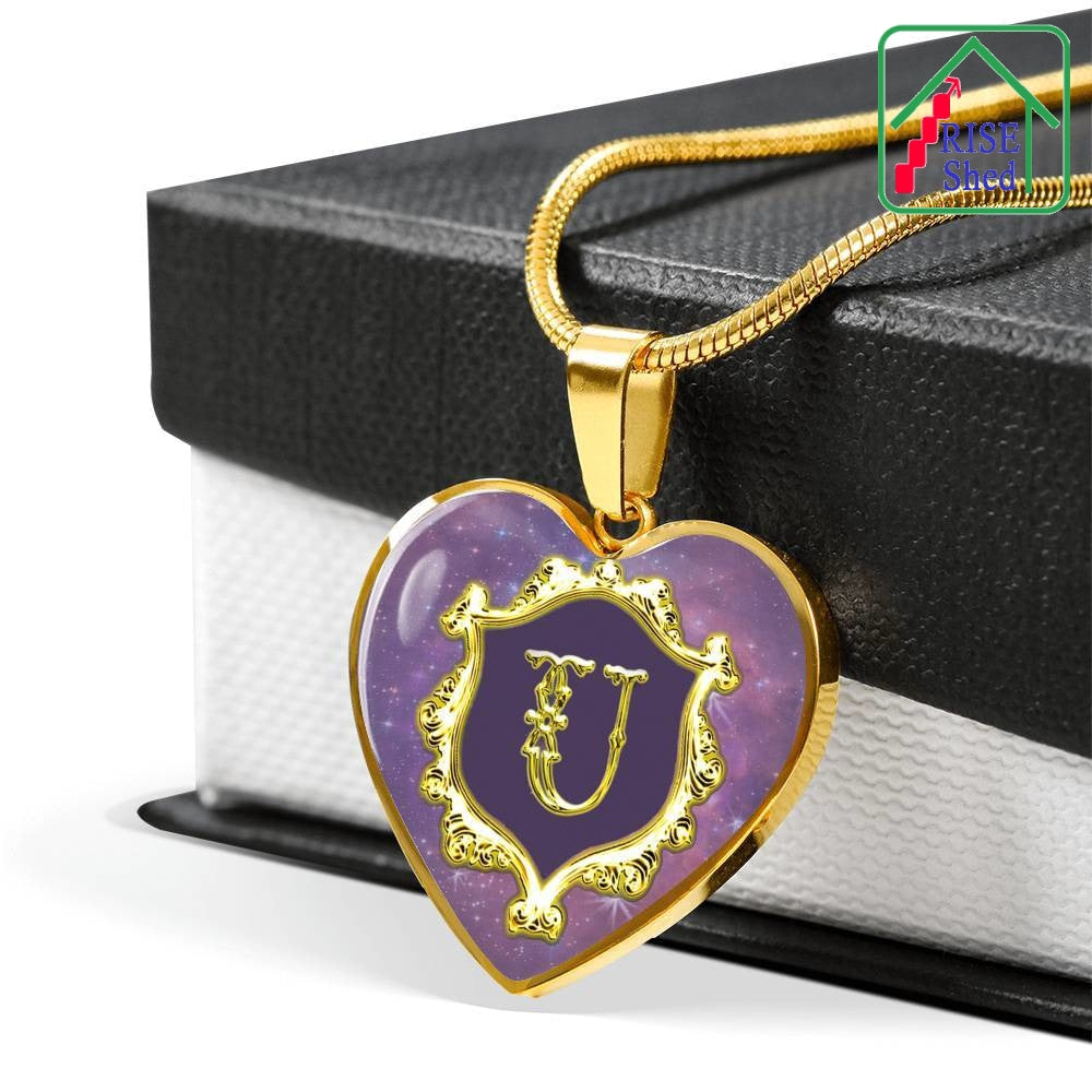 U Initial Monogram Alphabet 18K Gold Finish Heart Pendant and Necklace draped over giftbox