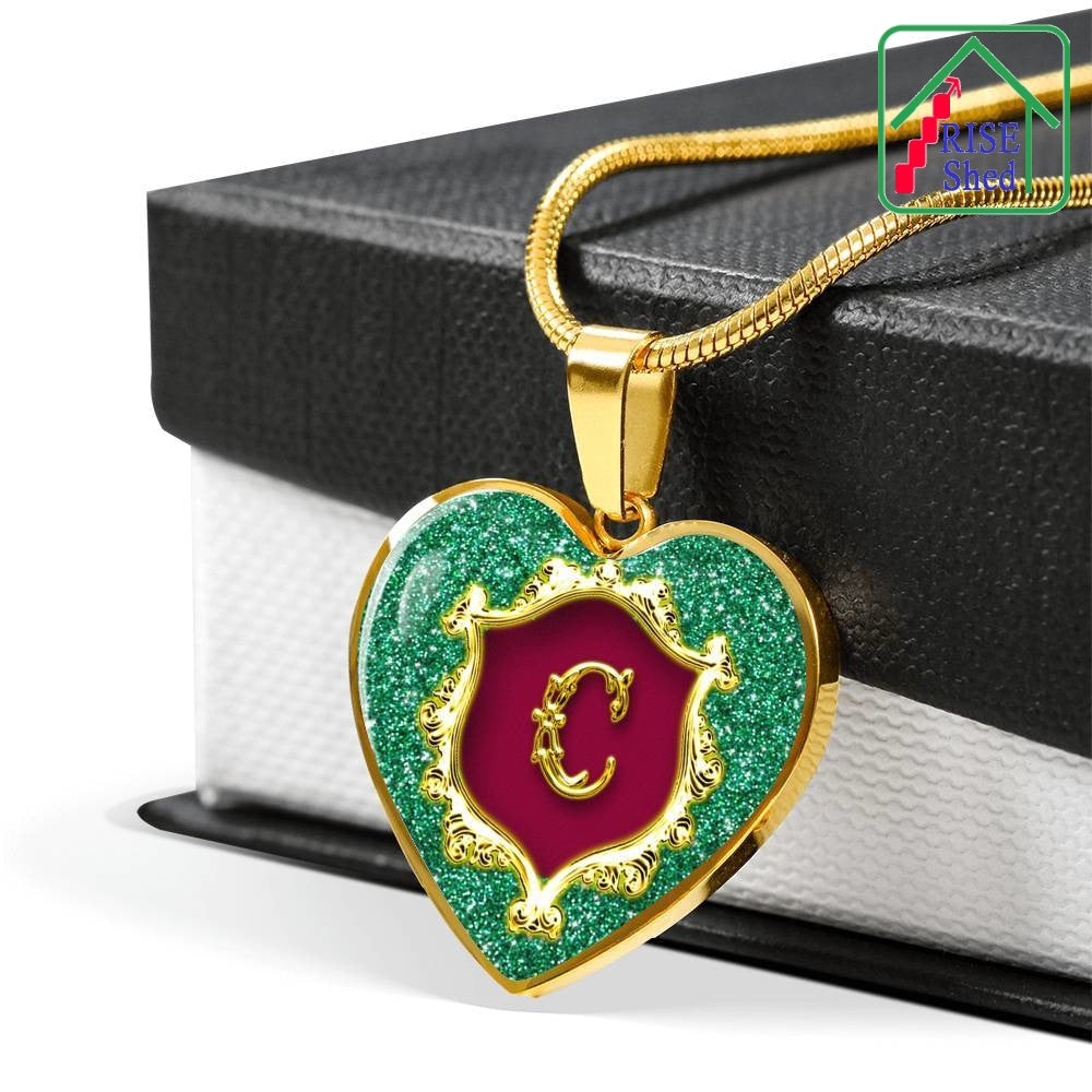18K Gold Finish C Initial Monogram Alphabet Heart Pendant and Necklace draped over giftbox