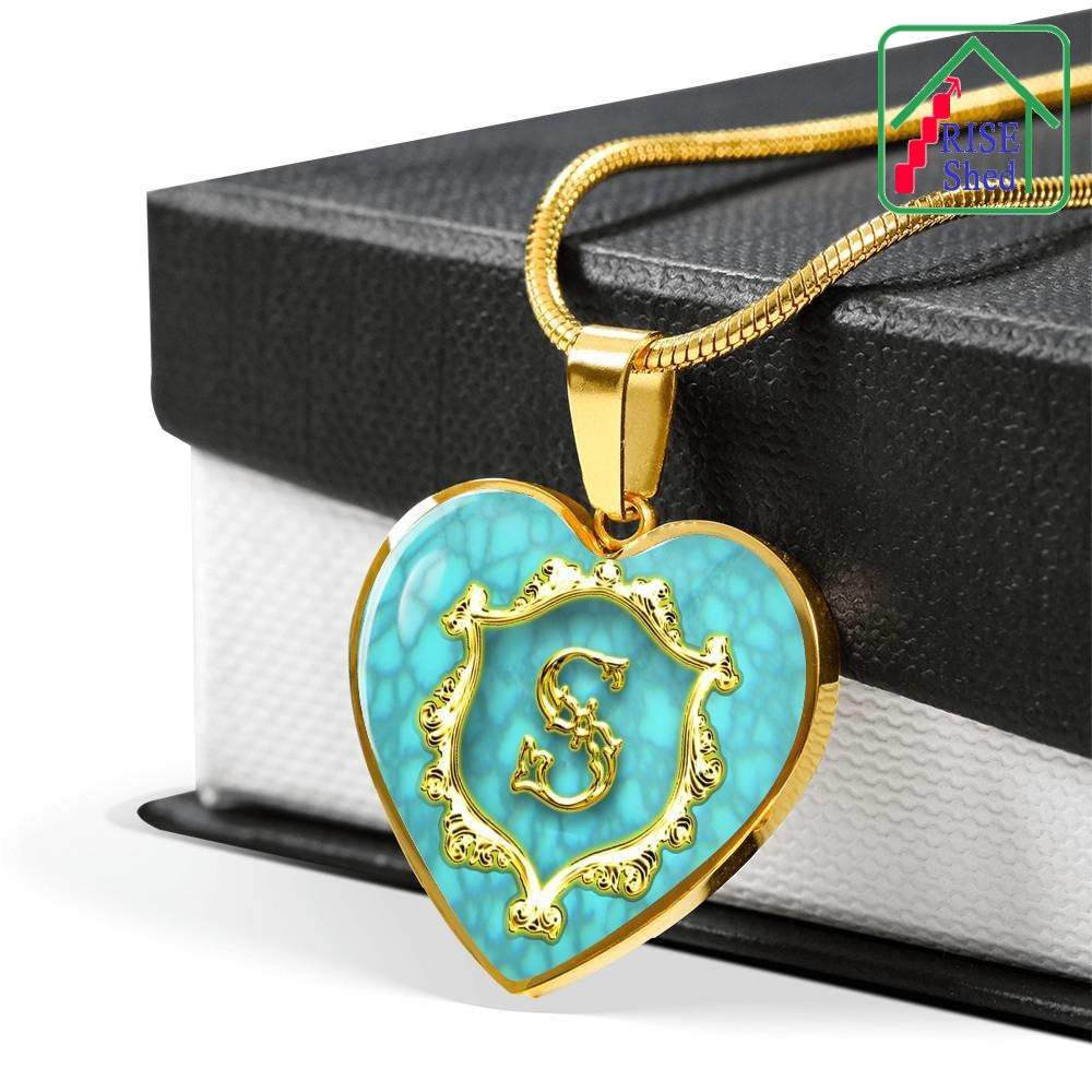 S Initial Monogram Alphabet 18K Gold Finish Heart Pendant and Necklace Turquoise Background draped over giftbox