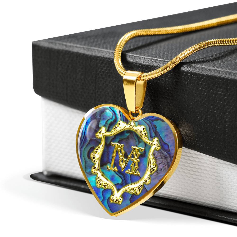 M Initial Monogram Alphabet 18K Gold Finish Heart Pendant and Necklace draped over giftbox