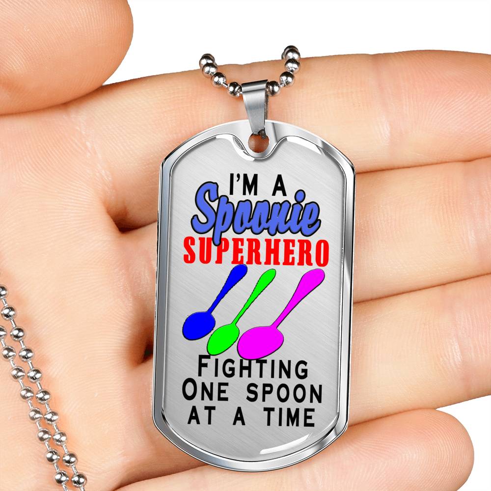 Spoonie Superhero Fighting One Spoon At A Time Dog Tag displayed in a hand