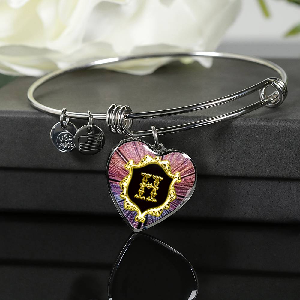 Heart Pendant H Monogram Alphabet Initial Bangle placed on top of giftbox