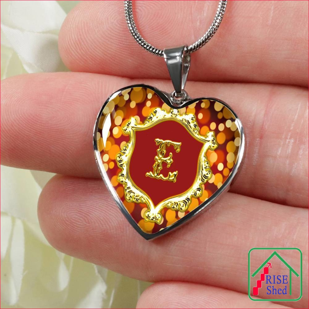 Close up of E Initial Monogram Alphabet Heart Pendant and Necklace being held in hand