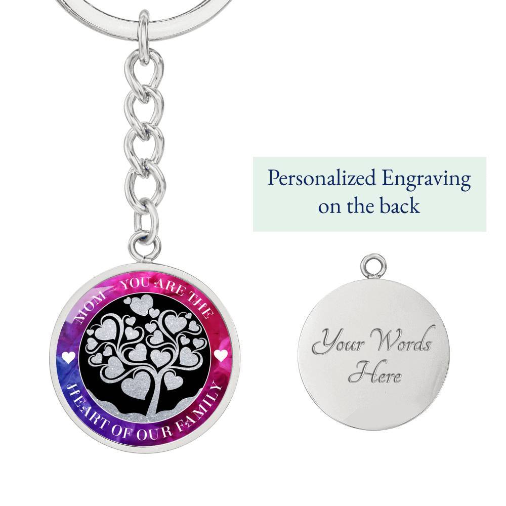 Mom - You are the Heart of our Family Keychain front view on the left with the back view on the right, under a heading which says, "Personalized Engraving on the back". The back of pendant is engraved with text, "Your Words Here"