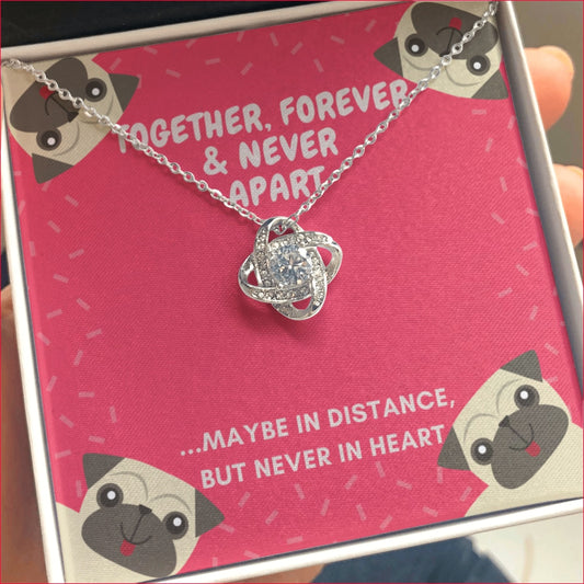 Pug Together Forever CZ Love Knot Pendant is gift boxed with a red background greetings style card with a pug face drawn in each corner of the message card which reads:      " TOGETHER, FOREVER & NEVER APART     ....MAYBE IN DISTANCE, BUT NEVER IN HEART"