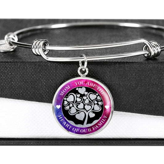 Mom- you are the heart of our family, stackable wire bangle rests on top of a black and white gift box with the glass domed graphic charm pendant dangling over the side